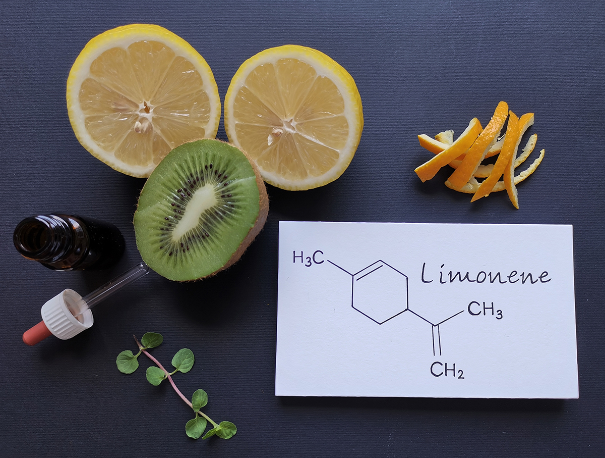 Structural chemical formula of limonene with fresh citrus fruit